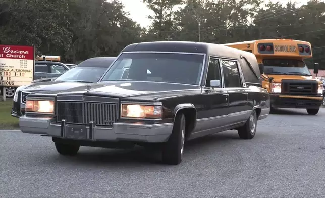 A hearse heads to Meridian Dock in McIntosh county where several people after a gangway collapsed plunging them into the water, on Sapelo Island, Ga in McIntosh county, Sunday, Oct. 20, 2024. (AP Photo/Lewis M. Levine)