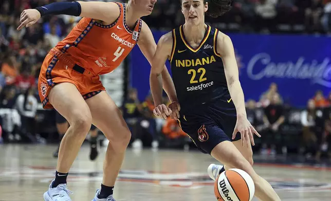 Connecticut Sun's Marina Mabrey (4) guards against Indiana Fever's Caitlin Clark (22) during a first-round WNBA basketball playoff game at Mohegan Sun Arena, Sunday, Sept. 22, 2024. (Sarah Gordon/The Day via AP)