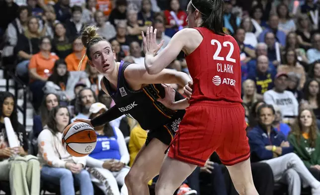 Connecticut Sun guard Marina Mabrey, left, is guarded by Indiana Fever guard Caitlin Clark during the second half of a first-round WNBA basketball playoff game, Wednesday, Sept. 25, 2024, in Uncasville, Conn. (AP Photo/Jessica Hill)