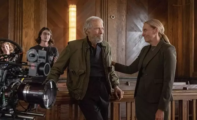 This image released by Warner Bros. Entertainment shows director Clint Eastwood, left, and Toni Collette behind the scenes during production for "Juror #2". (Warner Bros. Entertainment via AP)