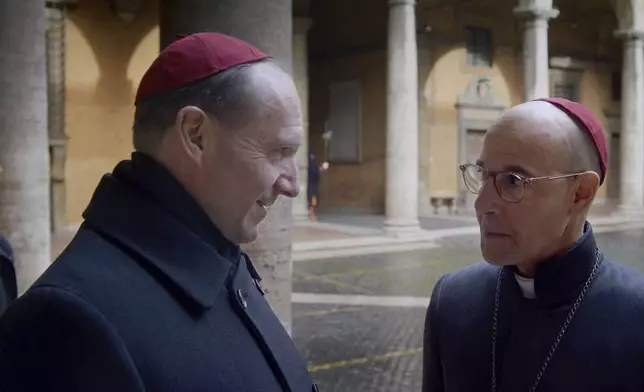 This image released by Focus Features shows Ralph Fiennes and Stanley Tucci, right, in a scene from "Conclave." (Focus Features via AP)