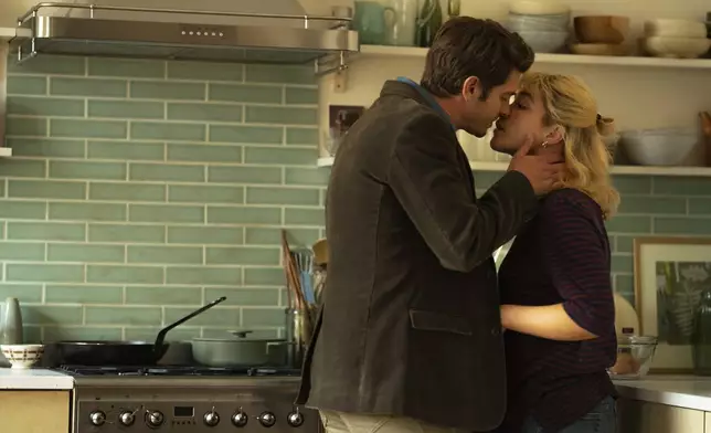 This image released by A24 shows Andrew Garfield, left, and Florence Pugh in a scene from "We Live In Time." (Peter Mountain/A24 via AP)