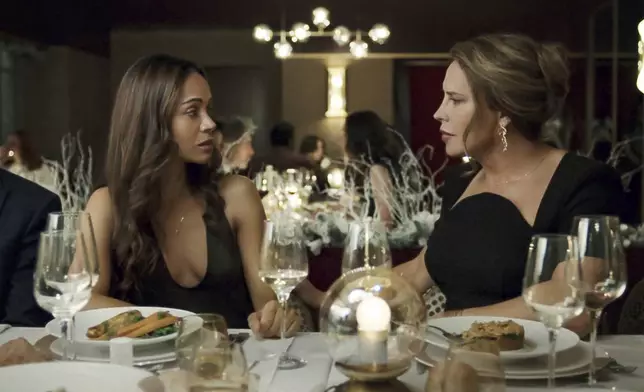 This image released by Netflix shows Karla Sofía Gascón, right, and Zoe Saldaña in a scene from "Emilia Pérez." (Shanna Besson/Netflix via AP)