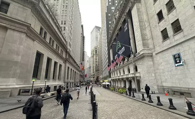 The New York Stock Exchange, right, is shown on Tuesday, Oct. 1, 2024, in New York. (AP Photo/Peter Morgan)