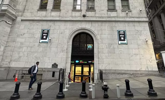 FILE - A man approaches an entrance to the New York Stock Exchange on Sept. 26, 2024, in New York. (AP Photo/Peter Morgan, File)