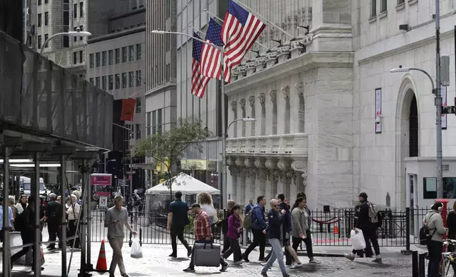 FILE - People pass the New York Stock Exchange on Oct. 1, 2024, in New York. (AP Photo/Peter Morgan, File)