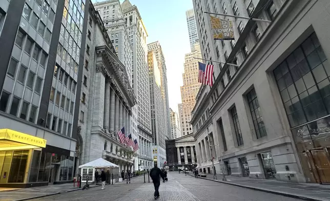 FILE - American flags, left, hang from the New York Stock Exchange on Oct. 16, 2024, in New York. (AP Photo/Peter Morgan, File)