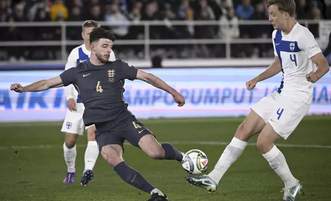 Finland's Robert Ivanov, right, challenges for the ball with England's Declan Rice during the UEFA Nations League soccer match between Finland and England, at the Olympic Stadium in Helsinki, Finland, Sunday, Oct. 13, 2024. (Antti Aimo-Koivisto/Lehtikuva via AP)