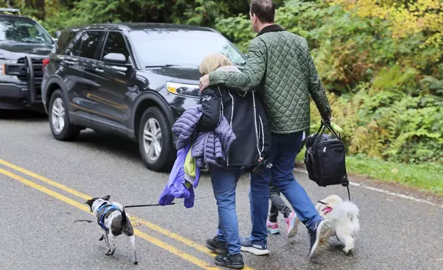 FILE - Neighbors leave the scene of a fatal shooting Monday morning, Oct. 21, 2024, in Fall City, Wash. (Kevin Clark/The Seattle Times via AP, File)