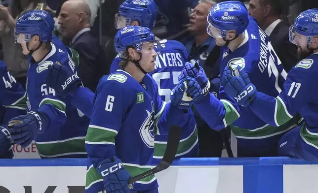 Vancouver Canucks' Brock Boeser (6) celebrates his second goal against the Calgary Flames during the first period of an NHL hockey game in Vancouver, British Columbia, Wednesday, Oct. 9, 2024. (Darryl Dyck/The Canadian Press via AP)