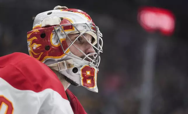 Calgary Flames goalie Dan Vladar skates to the corner during a stoppage in play during the third period of an NHL hockey game against the Vancouver Canucks in Vancouver, British Columbia, Wednesday, Oct. 9, 2024. (Darryl Dyck/The Canadian Press via AP)