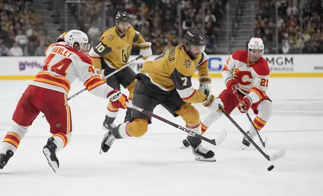 Vegas Golden Knights defenseman Alex Pietrangelo (7) skates against Calgary Flames defenseman Joel Hanley (44) during the second period of an NHL hockey game Monday, Oct. 28, 2024, in Las Vegas. (AP Photo/John Locher)