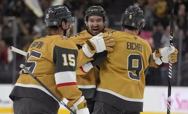 Vegas Golden Knights right wing Mark Stone, center, celebrates after scoring against the Calgary Flames during the second period of an NHL hockey game Monday, Oct. 28, 2024, in Las Vegas. (AP Photo/John Locher)