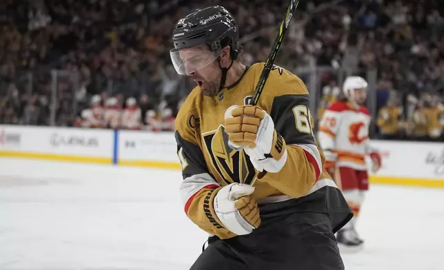 Vegas Golden Knights right wing Mark Stone (61) celebrates after scoring against the Calgary Flames during the second period of an NHL hockey game Monday, Oct. 28, 2024, in Las Vegas. (AP Photo/John Locher)