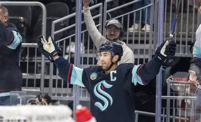 Seattle Kraken forward Jordan Eberle celebrates after scoring a goal in overtime of an NHL hockey game against the Calgary Flames, Saturday, Oct. 19, 2024, in Seattle. (AP Photo/Stephen Brashear)