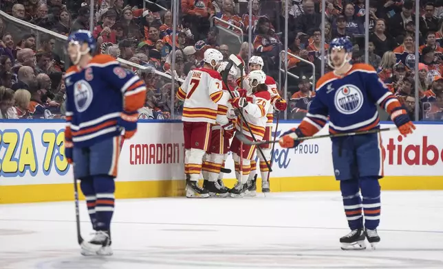 Calgary Flames celebrate a goal against the Edmonton Oilers during second period NHL action in Edmonton, Alberta, Sunday, Oct. 13, 2024. (Jason Franson/The Canadian Press via AP)