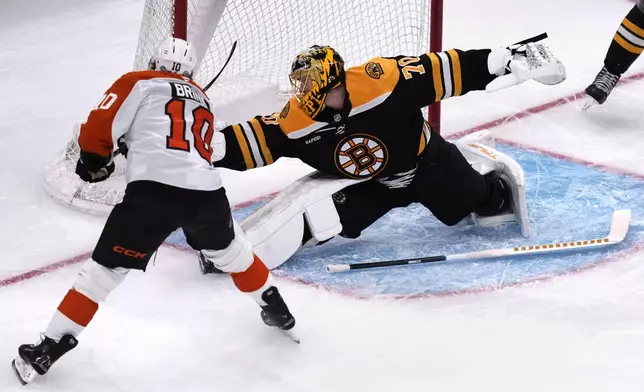 Boston Bruins goaltender Joonas Korpisalo makes a stickless save on a shot by Philadelphia Flyers right wing Bobby Brink during the first period of an NHL hockey game, Tuesday, Oct. 29, 2024, in Foxborough, Mass. (AP Photo/Charles Krupa)