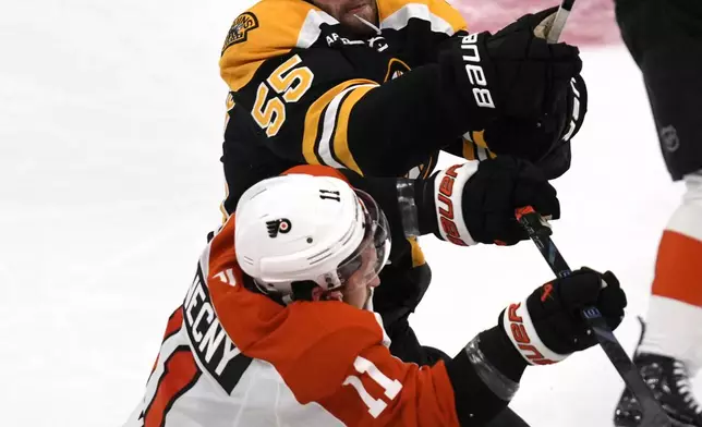 Boston Bruins right wing Justin Brazeau (55) and Philadelphia Flyers right wing Travis Konecny (11) collide during the first period of an NHL hockey game, Tuesday, Oct. 29, 2024, in Foxborough, Mass. (AP Photo/Charles Krupa)