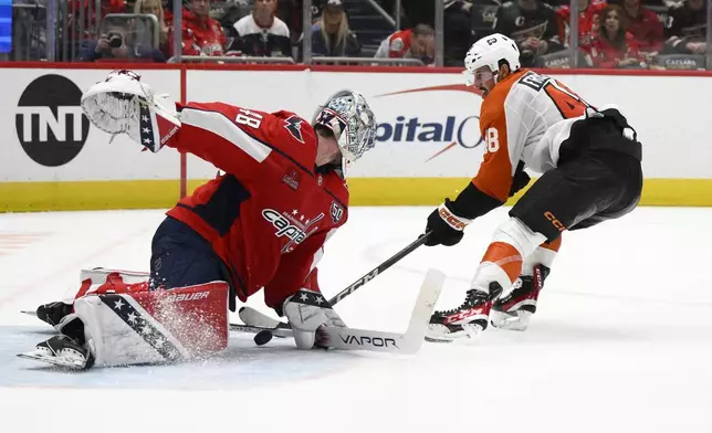 Washington Capitals goaltender Logan Thompson (48) stops a shot by Philadelphia Flyers center Morgan Frost (48) during the second period of an NHL hockey game, Wednesday, Oct. 23, 2024, in Washington. (AP Photo/Nick Wass)