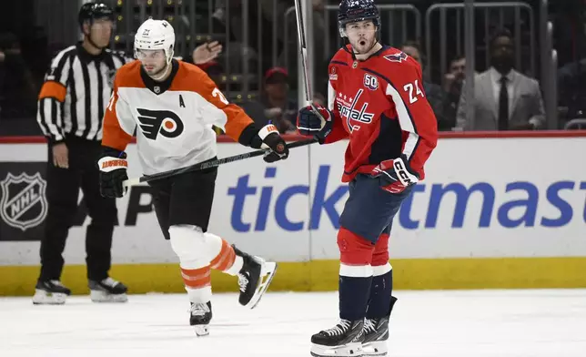 Washington Capitals center Connor McMichael (24) celebrates his goal next to Philadelphia Flyers center Scott Laughton (21) during the second period of an NHL hockey game, Wednesday, Oct. 23, 2024, in Washington. (AP Photo/Nick Wass)