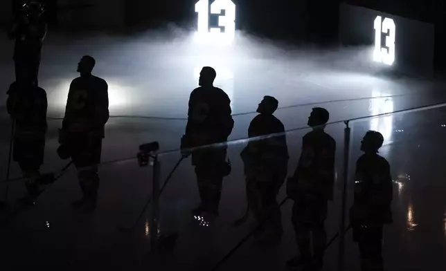 The number, 13, worn by former Calgary Flames player Johnny Gaudreau, is displayed during a memorial ceremony prior to an NHL hockey game against the Philadelphia Flyers in Calgary, Alberta, Saturday, Oct. 12, 2024. (Jeff McIntosh/The Canadian Press via AP)