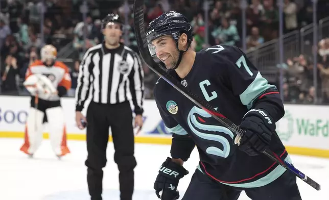 Seattle Kraken right wing Jordan Eberle (7) skates away after scoring against Philadelphia Flyers goaltender Ivan Fedotov, background left, during the second period of an NHL hockey game Thursday, Oct. 17, 2024, in Seattle. (AP Photo/Jason Redmond)