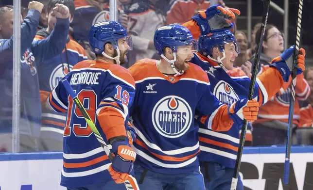 Edmonton Oilers' Adam Henrique (19), Connor Brown (28) and Jeff Skinner (53) celebrate their goal against the Philadelphia Flyers during the second period of an NHL hockey in Edmonton, Alberta, Tuesday, Oct. 15, 2024. (Amber Bracken/The Canadian Press via AP)