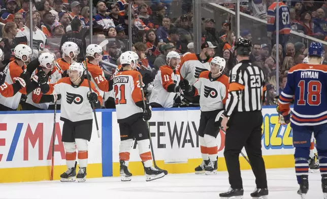 Philadelphia Flyers' Bobby Brink, front left, Scott Laughton (21) and Tyson Foerster (71) celebrate their goal against the Edmonton Oilers during the second period of an NHL hockey game in Edmonton, Alberta, Tuesday, Oct. 15, 2024. (Amber Bracken/The Canadian Press via AP)