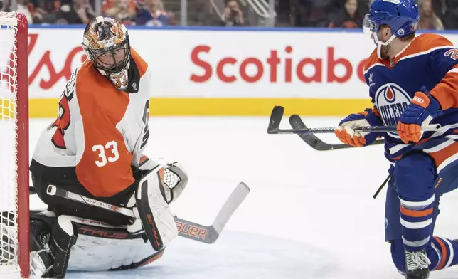 Philadelphia Flyers goalie Samuel Ersson (33) is scored on by Edmonton Oilers' Connor Brown (28) during the second period of an NHL hockey game in Edmonton, Alberta, Tuesday, Oct. 15, 2024. (Amber Bracken/The Canadian Press via AP)