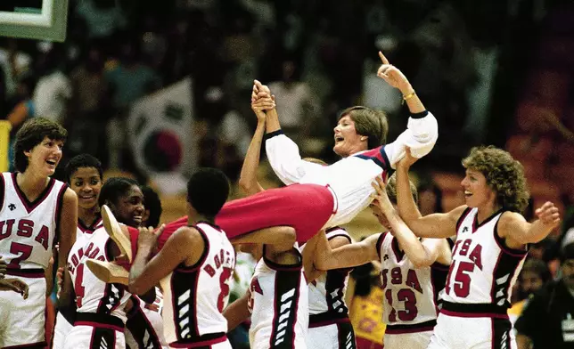 FILE - U.S. women's basketball coach Pat Summitt is carried off by members of the team following their 85-55 Olympic gold medal win over South Korea in Los Angeles, Aug. 8, 1984. (AP Photo/Pete Leabo, File)