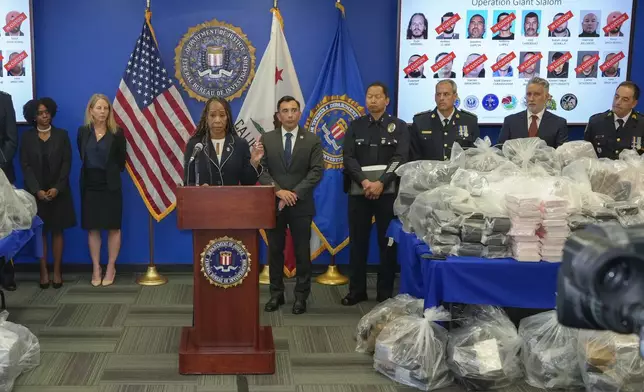 FBI Special Agent in Charge Krysti Hawkins, at podium, joined by federal, local, and international officials, announces federal charges and arrests of alleged members of a transnational drug trafficking operation that routinely shipped hundreds of kilograms of cocaine from Colombia, through Mexico and Southern California, to Canada and other locations in the United States, during a news conference at the FBI offices in Los Angeles, Thursday, Oct. 17, 2024. (AP Photo/Damian Dovarganes)