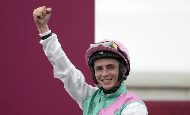 Jockey Rossa Ryan, riding Bluestocking, celebrates after winning the Prix de l'Arc de Triomphe horse race at the Longchamp race track, outside Paris, Sunday, Oct. 6, 2024. (AP Photo/Michel Euler)