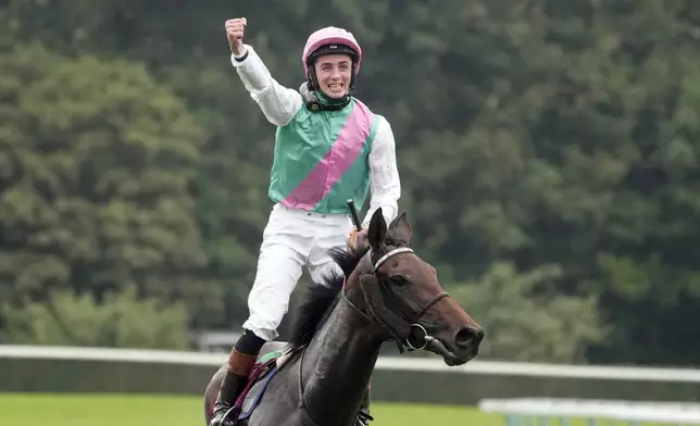 Jockey Rossa Ryan, riding Bluestocking, celebrates after winning the Prix de l'Arc de Triomphe horse race at the Longchamp race track, outside Paris, Sunday, Oct. 6, 2024. (AP Photo/Michel Euler)