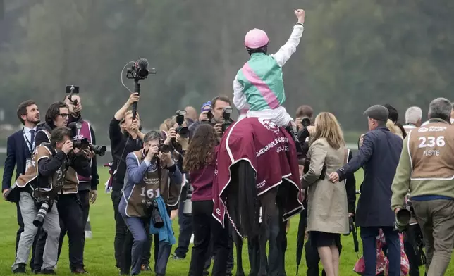 Jockey Rossa Ryan, riding Bluestocking, celebrates after winning the Prix de l'Arc de Triomphe horse race at the Longchamp race track, outside Paris, Sunday, Oct. 6, 2024. (AP Photo/Michel Euler)