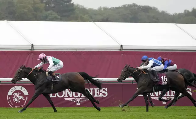 Bluestocking, ridden by Rossa Ryan, races ahead of Aventure, ridden by Stephane Pasquier, to win the Prix de l'Arc de Triomphe horse race at the Longchamp race track, outside Paris, Sunday, Oct. 6, 2024. (AP Photo/Michel Euler)