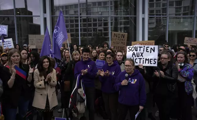 Women's rights activists demonstrate outside the Paris palace of justice as French actor Gérard Depardieu, who is facing trial for the alleged sexual assaults of two women on a film set in 2021, won't appear before a criminal court, Monday, Oct. 28, 2024 in Paris. (AP Photo/Louise Delmotte)