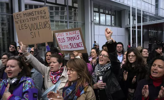 Women's rights activists demonstrate outside the Paris palace of justice as French actor Gérard Depardieu, who is facing trial for the alleged sexual assaults of two women on a film set in 2021, won't appear before a criminal court, Monday, Oct. 28, 2024 in Paris. (AP Photo/Louise Delmotte)