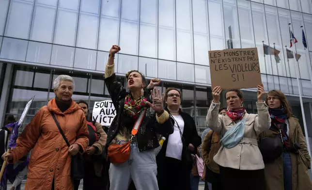 Women's rights activists demonstrate outside the Paris palace of justice as French actor Gérard Depardieu, who is facing trial for the alleged sexual assaults of two women on a film set in 2021, won't appear before a criminal court, Monday, Oct. 28, 2024 in Paris. (AP Photo/Louise Delmotte)