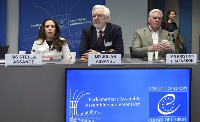 Wikileaks founder Julian Assange, center, his wife Stella Assange, left, and editor-in-chief of WikiLeaks Kristin Hrafnsson, listen the open speech at the Council of Europe while his wife Stella Assange sits next to him, in Strasbourg, eastern France, Tuesday, Oct. 1, 2024. (AP Photo/Pascal Bastien)