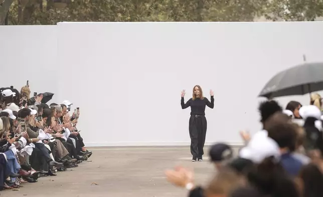 Designer Stella McCartney accepts applause after her Spring/Summer 2025 collection presented Monday, Sept. 30, 2024 in Paris. (Photo by Scott A Garfitt/Invision/AP)