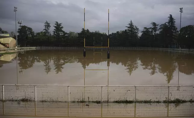 A rugby pitch is flooded in Givors, central France, after torrential rains and flooding submerged roads and railways, Friday, Oct. 18, 2024. (AP Photo/Laurent Cirpiani)