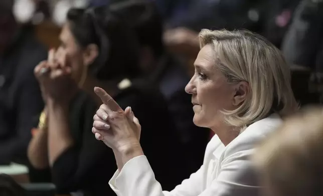 French far-right leader Marine Le Pen reacts during the speech of Prime Minister Michel Barnier at the National Assembly, in Paris, Tuesday, Oct. 1, 2024. (AP Photo/Thibault Camus)