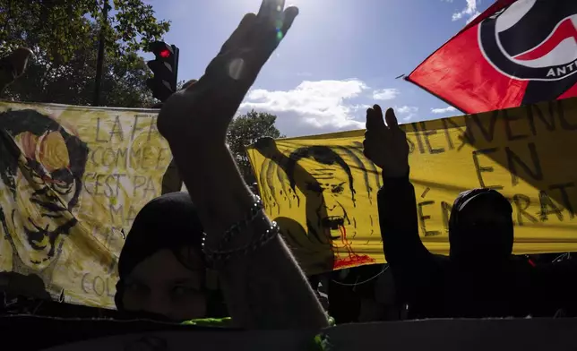 Protesters march during a rally against the new government of French Prime Minister Michel Barnier, in Paris, Tuesday, Oct. 1, 2024. (AP Photo/Louise Delmotte)