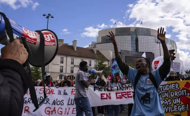 Protesters march during a rally against the new government of French Prime Minister Michel Barnier, in Paris, Tuesday, Oct. 1, 2024. (AP Photo/Louise Delmotte)