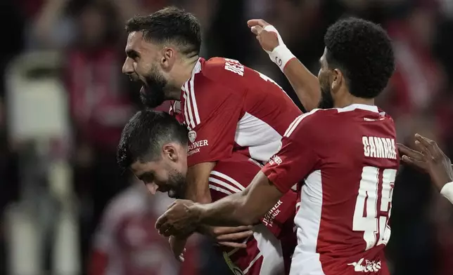 Brest players celebrate after a goal during the Champions League opening phase soccer match between Brest and Bayer Leverkusen in Guingamp, western France, Wednesday, Oct. 23, 2024. (AP Photo/Christophe Ena)