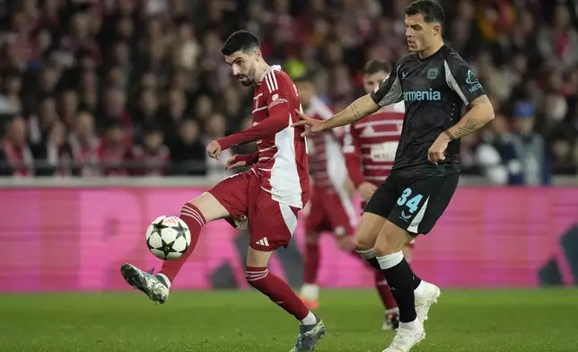 Brest's Pierre Lees-Melou passes the ball in front of Leverkusen's Granit Xhaka during the Champions League opening phase soccer match between Brest and Bayer Leverkusen in Guingamp, western France, Wednesday, Oct. 23, 2024. (AP Photo/Christophe Ena)