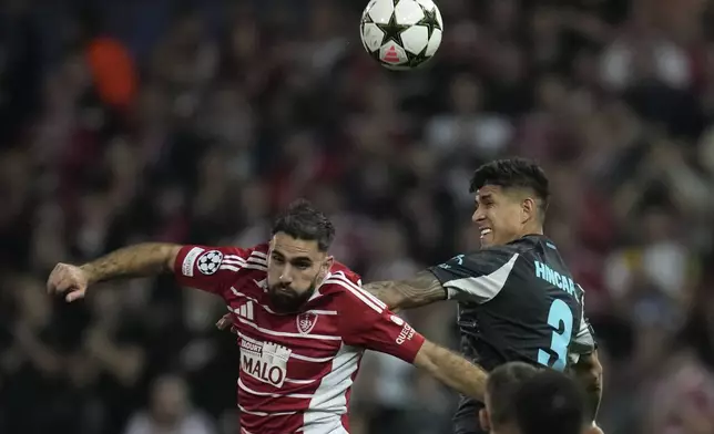 Brest's Romain Del Castillo, left, and Leverkusen's Piero Hincapie jump for the ball during the Champions League opening phase soccer match between Brest and Bayer Leverkusen in Guingamp, western France, Wednesday, Oct. 23, 2024. (AP Photo/Christophe Ena)