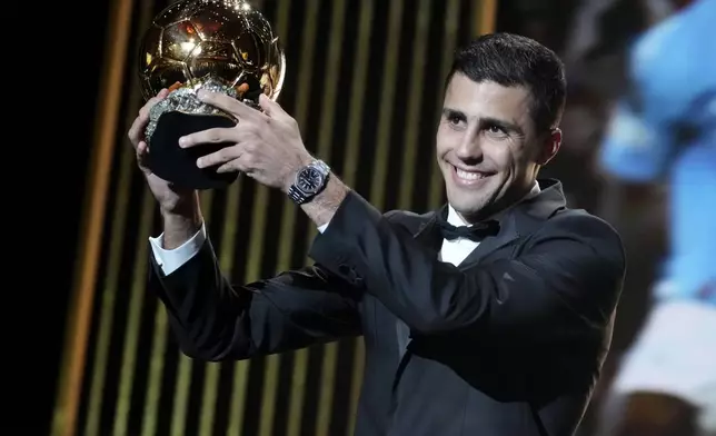 Spanish player Rodri receives the 2024 Men's Ballon d'Or award during the 68th Ballon d'Or (Golden Ball) award ceremony at Theatre du Chatelet in Paris, Monday, Oct. 28, 2024. (AP Photo/Michel Euler)