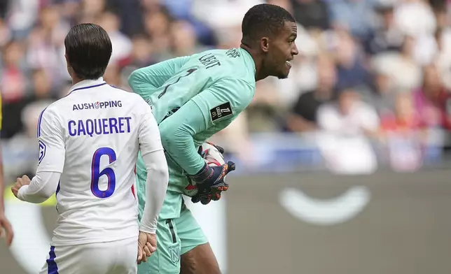 Nantes' goalkeeper Alban Lafont catches the ball during the French League One soccer match between Lyon and FC Nantes at the Groupama stadium in Decines, outside Lyon, France, Sunday, Oct. 6, 2024. (AP Photo/Laurent Cipriani)