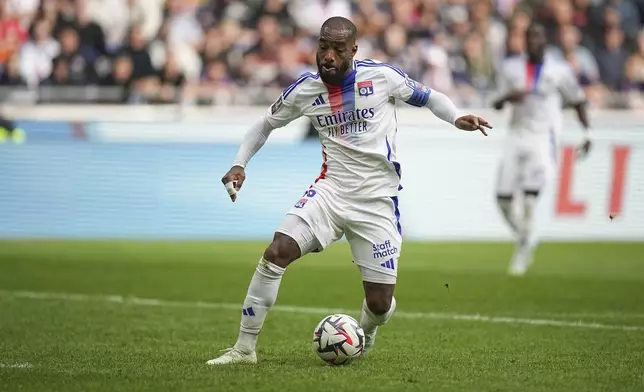 Lyon's Alexandre Lacazette dribbles the ball during the French League One soccer match between Lyon and FC Nantes at the Groupama stadium in Decines, outside Lyon, France, Sunday, Oct. 6, 2024. (AP Photo/Laurent Cipriani)